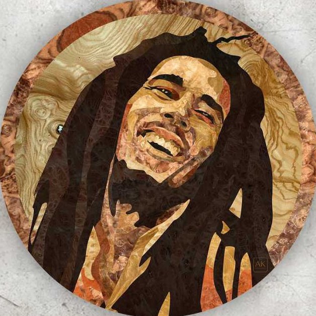 Bob Marley, a round natural wood veneer marquetry portrait by Aydin Kalantar