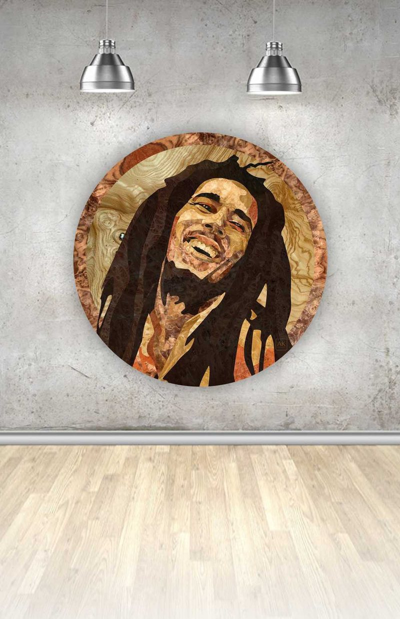 Bob Marley, natural wood veneer marquetry portrait by Aydin Kalantar, shown hanging on a gallery wall